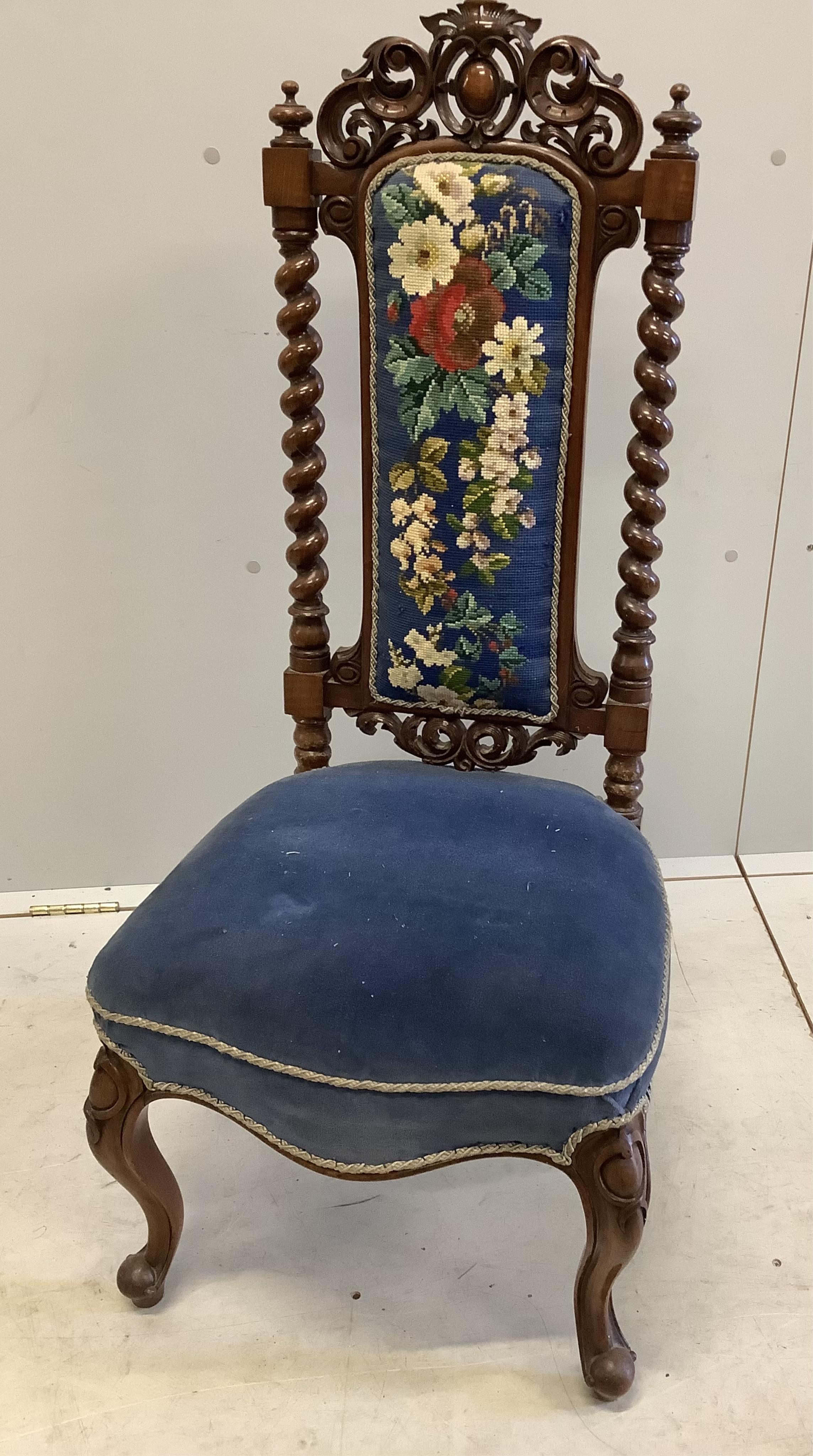 A pair of Victorian carved walnut side chairs with polychrome floral upholstered backs, width 46cm, depth 40cm, height 104cm. Condition - fair to good